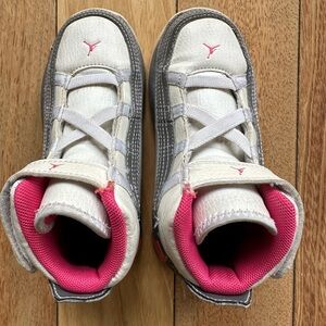 Air Jordan Retro 23 toddler sneakers in white, pink and gray.  Velcro closure.